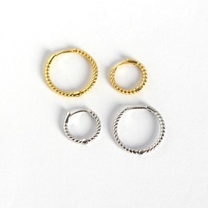 Twisted rope hoop earrings in gold and silver finishes across two different sizes