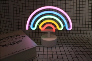 Rainbow LED neon sign on white base glowing with vibrant multi-colored light detail