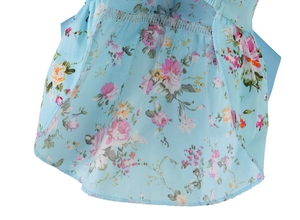 Detailed close-up of sky blue floral pet dress showing cotton fabric and hem stitching