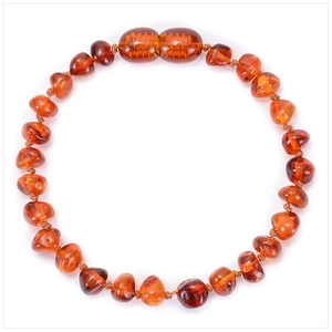 Macro shot of cognac amber baby bracelet with irregular beads and screw clasp detail