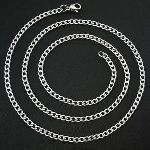 Detailed view of silver Cuban link necklace with lobster clasp on black background