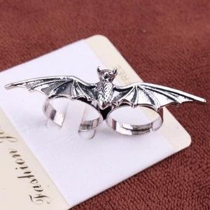 Detailed view of a vintage silver bat double-finger adjustable ring on card display