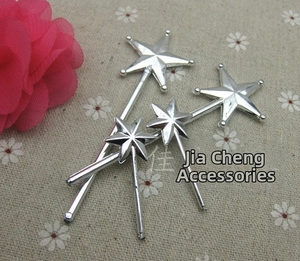 Macro detail of four silver-plated star wands for DIY accessories and crafts