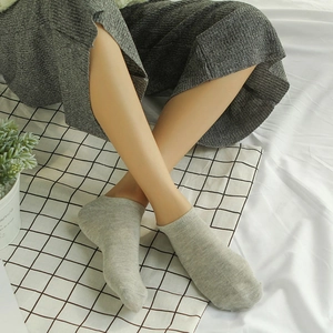 Gray low-cut cotton ankle socks for women with soft knit texture on a natural background