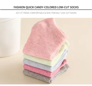 Close-up of candy-colored cotton ankle socks stacked with breathable knit texture