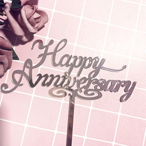 Mirror acrylic Happy Anniversary cake topper on pink grid with decorative roses