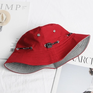 Detail of red outdoor bucket hat with adjustable toggle drawcord and breathable eyelets