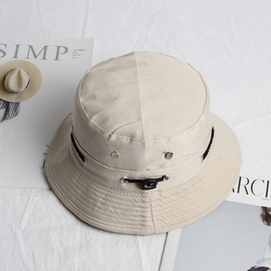 Detail of beige bucket hat featuring metal eyelets and adjustable rear drawcord closure