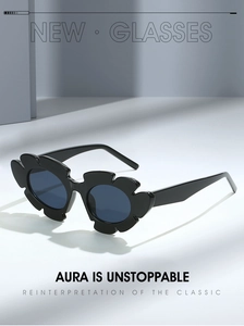 Close-up of black flower-shaped frame sunglasses with dark lenses on minimalist background