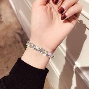 Close-up of elegant silver-toned double-row pave-set rhinestone bracelet on wrist
