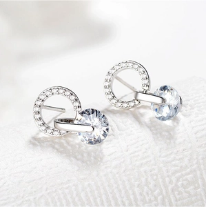 Detailed view of silver stud earrings with sparkling round cubic zirconia stones