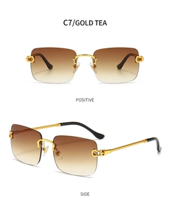 Detail view of gold metal twist temples and tea gradient lenses on rimless sunglasses