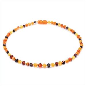 Top view of multicolored Baltic amber beads in honey, lemon, and cherry red round shapes