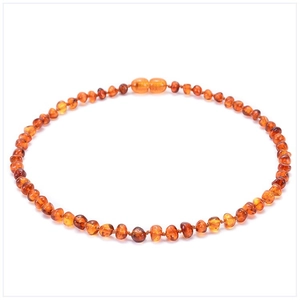 Detailed view of Baltic amber necklace beads with natural orange-brown gradient texture