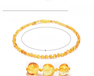 Macro shot of polished Baltic amber teething necklace beads showing natural texture and clarity