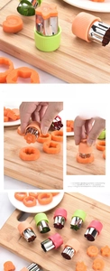 Detail view of heart and star stainless steel vegetable cutters with plastic hand guards