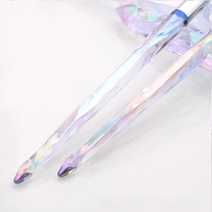 Macro detail of iridescent crystal makeup brush handles with silver metallic ferrule