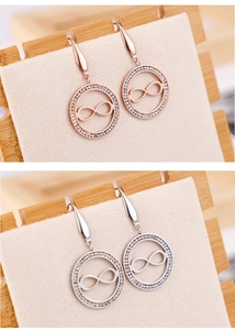 Détails de boucles d'oreilles rondes avec oxydes de zirconium et symbole infini bicolore