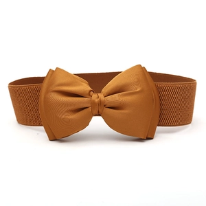 Detail of caramel brown elastic wide belt featuring a large satin double layer bow tie