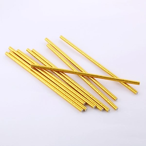 Close-up of metallic gold striped paper straws for birthday party and picnic decoration