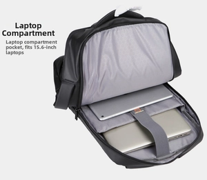 Detail of laptop compartment with velcro strap holding a silver laptop and tablet
