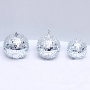 Silver laser mirror disco balls in three sizes with hanging rings on white background