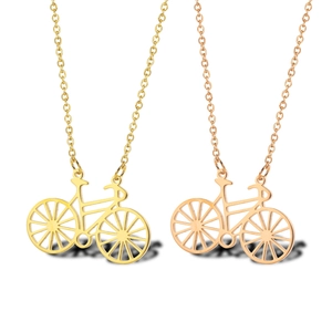 Detailed view of bicycle pendants in 18K gold and rose gold finishes with hollow design