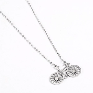 Detail of silver bicycle pendant necklace with delicate chain on white background