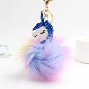 Colorful unicorn keychain with blue sequins and rainbow faux fur pom pom on gold ring