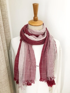 Detail shot of a red and white striped cotton-linen scarf with fringed edges