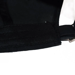 Close-up of black cotton baseball cap back strap with precision stitching and metal buckle