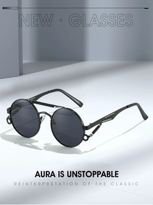 Close-up of steampunk round metal sunglasses featuring industrial spring hinge details