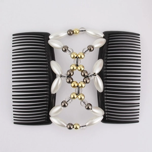 Detail of double-row magic hair comb with white gold and black beaded butterfly pattern