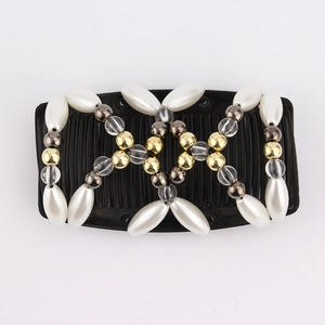 Macro detail of double-row magic hair comb with white faux pearls and gold beads