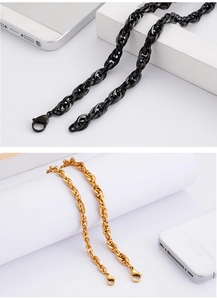 Detail of black and gold 18K plated stainless steel necklaces with lobster clasps