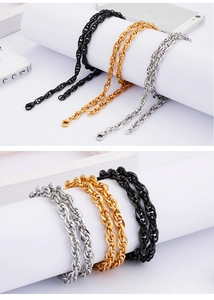 Detailed view of twisted rope chains in black, gold, and silver stainless steel finishes