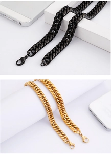 Close-up of gold and black chunky Cuban link chains with secure lobster clasps