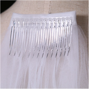 Detail of transparent plastic comb and double-layered white tulle bridal veil