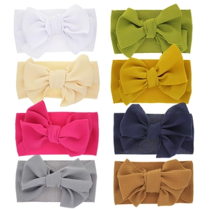 8-pack baby elastic headbands with large bows in waffle knit fabric and various colors