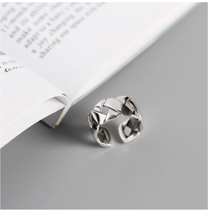 Macro shot of silver S925 sterling silver ring with woven geometric chain link texture
