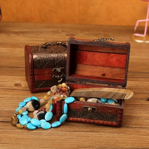 Vintage dark brown wooden jewelry box with carved texture and antique metal latch handle