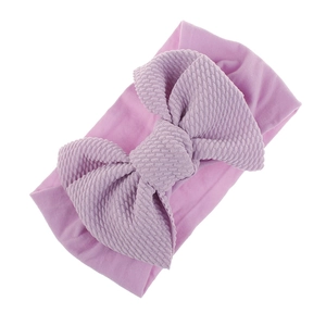 Close-up of lilac baby headband featuring soft stretchy nylon and textured bow detail