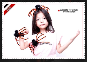 Detailed view of Halloween black spider headband and decor clip worn by a child