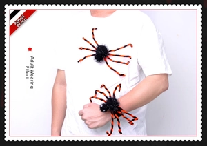 Detail of Halloween black and orange plush spider worn as a versatile wrist accessory