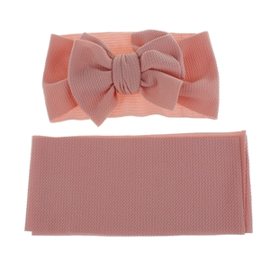 Pink infant bow headband set with ribbed waffle texture fabric on a plain background