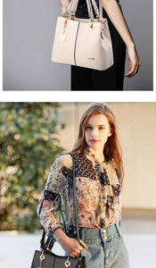 Detail of chic PU leather handbag with gold hardware and heart pendant in beige and black