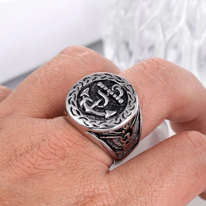 Macro shot of silver vintage anchor ring detail with eagle emblem on stainless steel