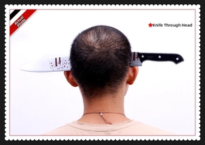 Detail of the realistic bloody fake knife headband for Halloween prank costume parties