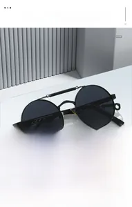 Detail view of steampunk round metal frame sunglasses with spring bridge and ornate temples