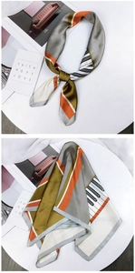 Detail view of colorful geometric silk scarf with piano key patterns and soft lighting